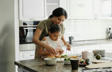 mother and daughter preparing avocado toast