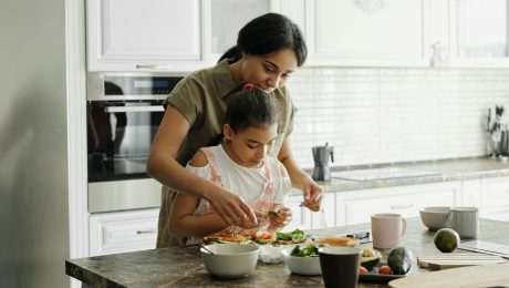 mother and daughter preparing avocado toast